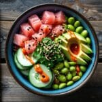 Delicious homemade poke bowl with fresh tuna, avocado, cucumbers, and sesame seeds.